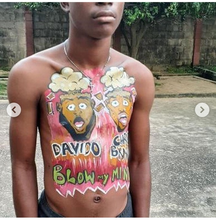 Davido’s die Hard fan gets the ‘Blow My Mind’ painting done on his chest. Davido collaborated with American singer, Chris Brown in in the trending song.
